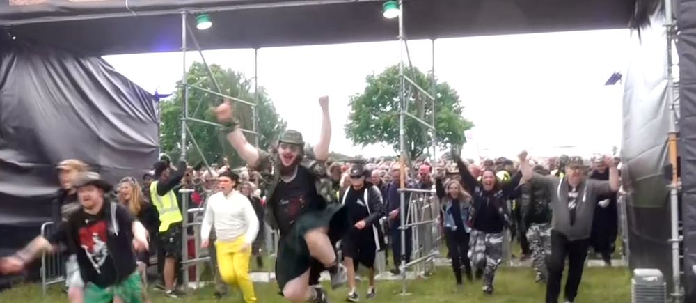 Glada personer som springer in under en stor banderoll med texten ”Sweden rock””