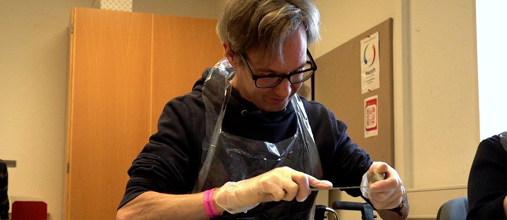 Peter Hindeborg jobbar med att plocka bort vekhållaren i järn från värmeljuskoppen i aluminium