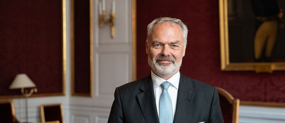 Jan Björklund, tidigare partiledare för Liberalerna, blir ny riksmarsalk vid hovet. Här fotad iklädd kostym i ett rum med röd tapet och inredning med gulddetaljer.