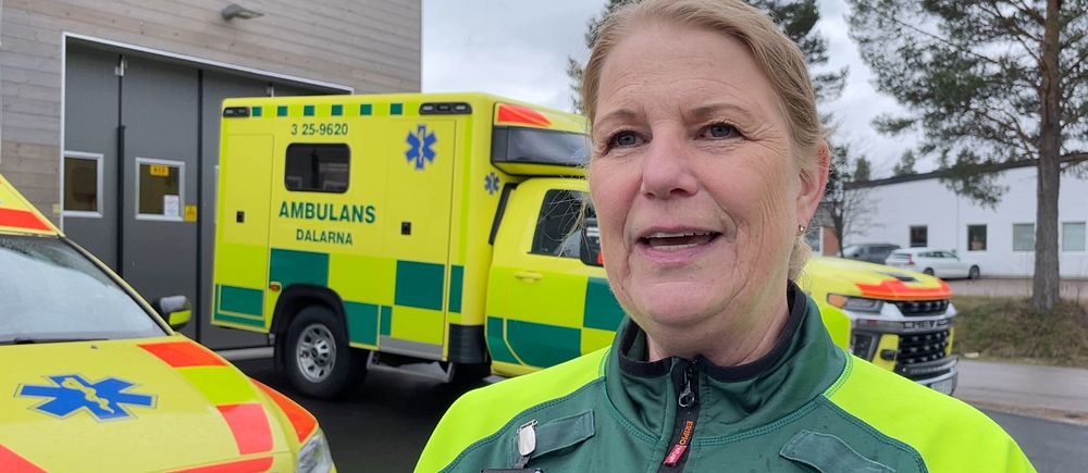 En ambulanssjuksköterska framför ambulanser
