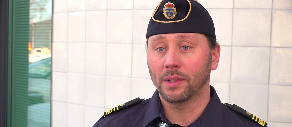 Polisens spaningschef i Västerbotten Thomas Palmgren står i uniform framför en kaklad vägg.