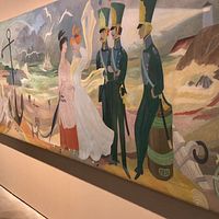 pitkähiuksinen nainen katsoo Tove Janssonin suurta seinämaalausta