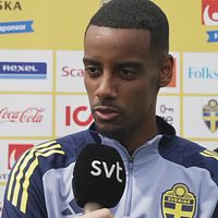 Person i svensk landslagströja intervjuas av SVT. Sponsorer synliga i bakgrunden.