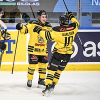 Tre ishockeyspelare från Vimmerby firar på isen.