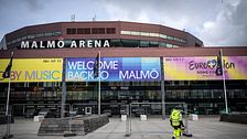Bild på Malmö Arena med skyltar om Eurovision.
