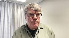Roger Johansson (S) intervjuas i ett grått rum.