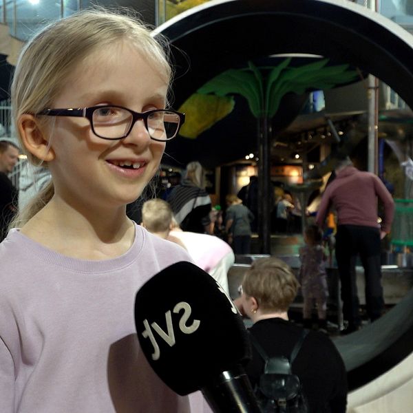 Sjuårige Astrid Gåverud framför ett stort hamsterhjul.