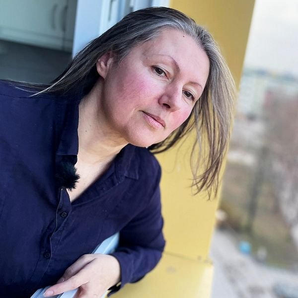 Lena ukrainsk flykting tittar ut ur fönster i Hageby efter explosion i Norrköping