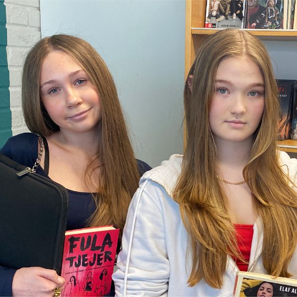 Emma Slagbrand, Anabelle Touminen och Amanda Dahl står framför en bokhylla och håller varsin ungdomsbok. De tycker att det är synd att allt färre ungdomsböcker ges ut.