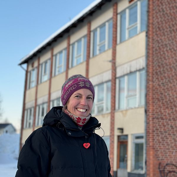 Ida Collin, ordförande för Övre Tåsjödalens Framtidförening, står framför den gamla skolan i Norråker