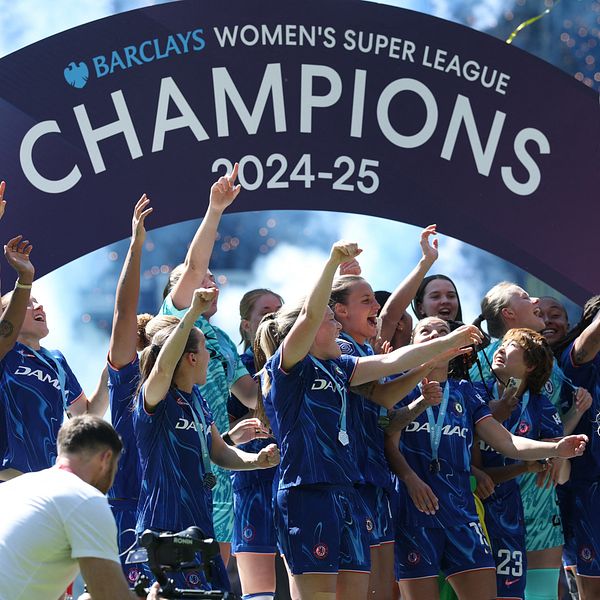 Segerglada fotbollsspelare firar under skylt för Barclays Women's Super League Champions 2024–25.