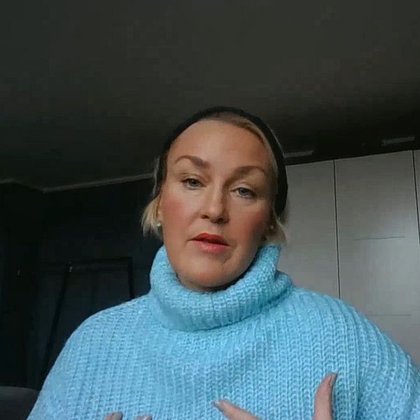 en kvinna i ljusblå tröja och hårband