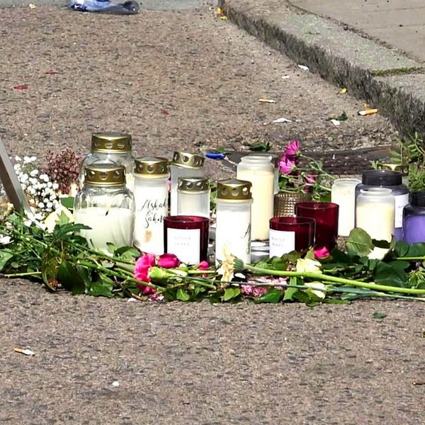Blommor och ljus på platsen för ett mord