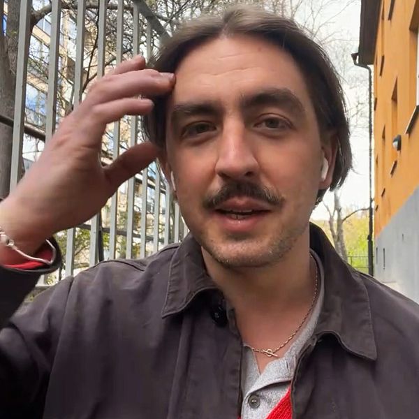 Jack Werner utomhus framför en byggnad, med handen mot huvudet