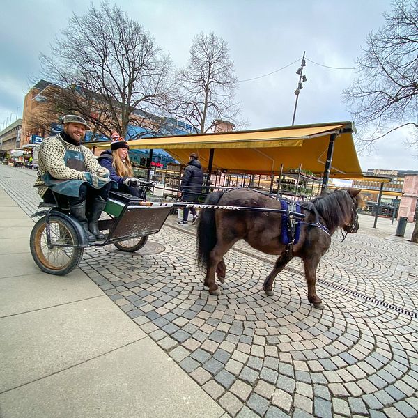 Häst och vagn på ett torg