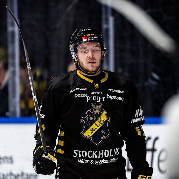 Hockeyspelare i AIK-tröja står på isen under en match.