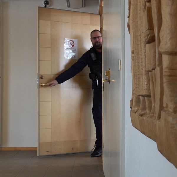 Vakt som stänger dörren till sal 1 i Ångermanlands tingsrätt,