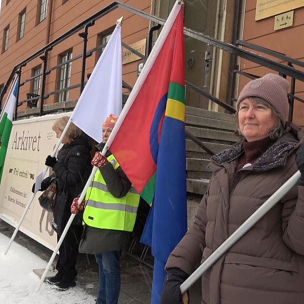 Personer demonstrerar utanför Riksarkivet med samiska och andra flaggor.