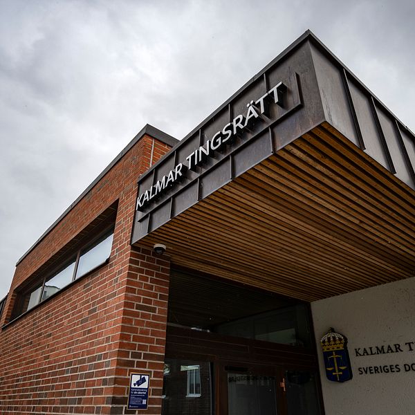 Kalmar tingsrätts byggnad, med en skylt längst upp till höger som tydligt visar namnet ”Kalmar Tingsrätt”. En flagga vajar på en flaggstång till vänster.