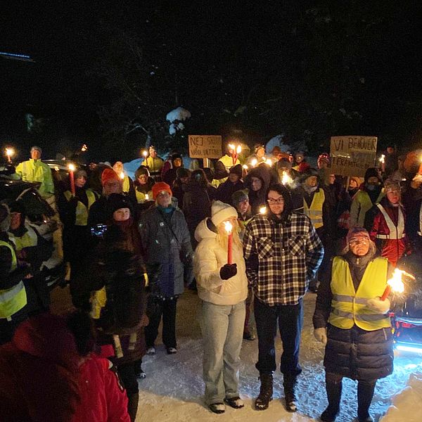 Flera personer i ett fackeltåg.