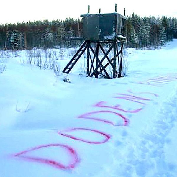 Jakttorn i snö med texten ”Dödens ring” skrivet med röd text i snön nedanför