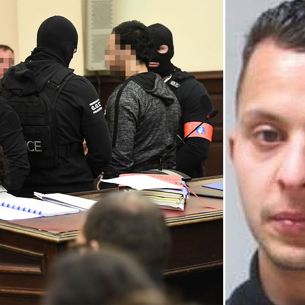 Maskerade poliser framför Salah Abdeslam i rättssalen i Bryssel.