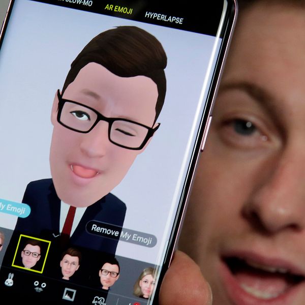 Mobiltelefon med app som gör om ditt ansikte till en emoji.
