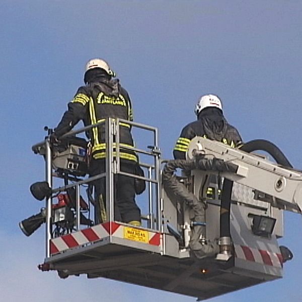 två brandmän i lyftkorg