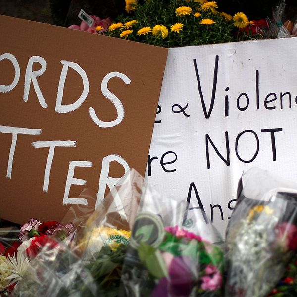 Plakat med texten ”ord har betydelse” bland blommor utanför synagogan Tree of Life i Pittsburgh