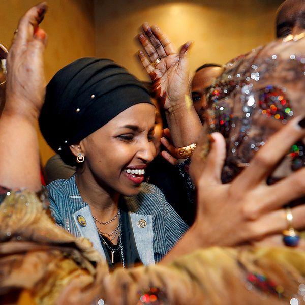 Ilhan Omar omfamnas av sin svärmor under nattens firande. Hon tar nu plats i representanthuset som första muslimska kvinna, tillsammans med Rashida Tlaib.
