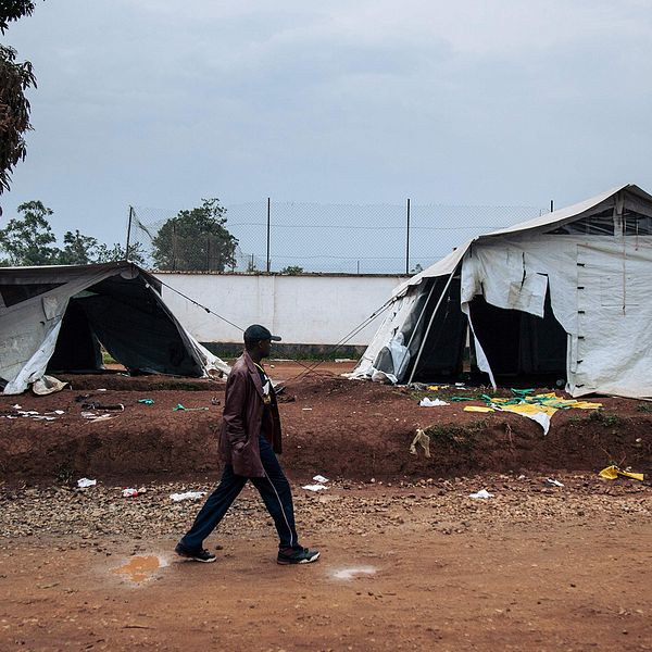 En man passerar tält som förstörts i demonstrationerna i staden Beni i Kongo-Kinshasa.