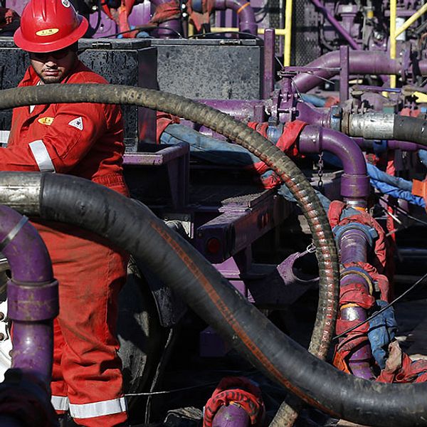 In this March 25, 2014 photo, a worker adjusts hoses during a hydraulic fracturing operation at an Encana Corp. gas well, near Mead, Colo. The first experimental use of hydraulic fracturing was in 1947, and more than 1 million U.S. oil and gas wells have been fracked since, according to the American Petroleum Institute. The National Petroleum Council estimates that up to 80 percent of natural gas wells drilled in the next decade will require hydraulic fracturing. (AP Photo/Brennan Linsley)