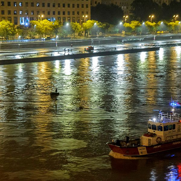 En räddningsbåt från den ungerska brandkåren letar efter överlevande i vattnet.