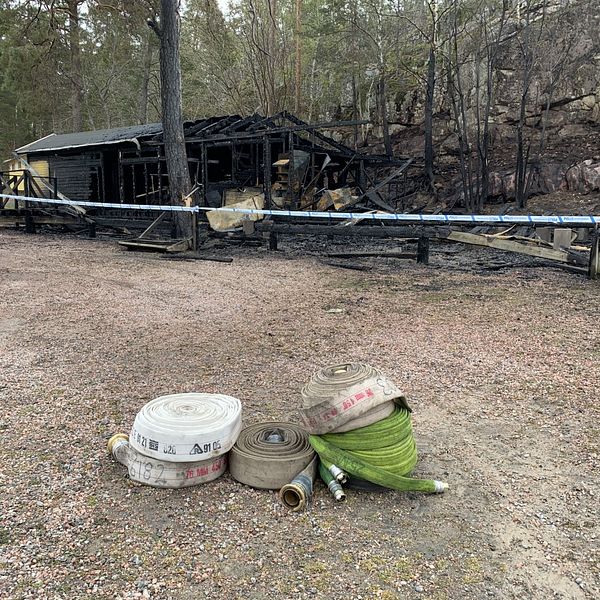 Skelettet av ett nedbrunnet, förkolnat hus.