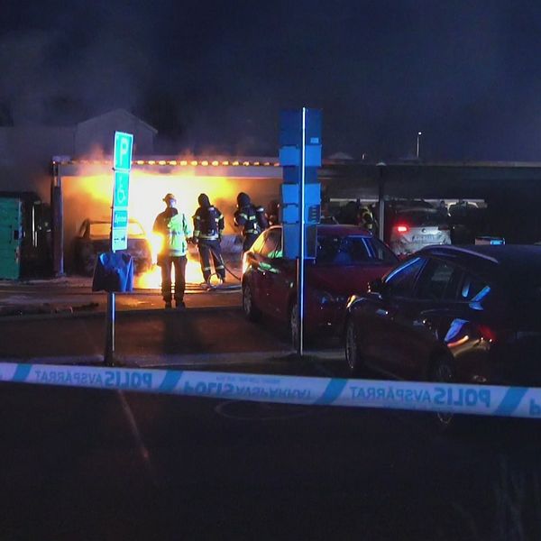 Räddningstjänsten släcker en brand i ett garage.