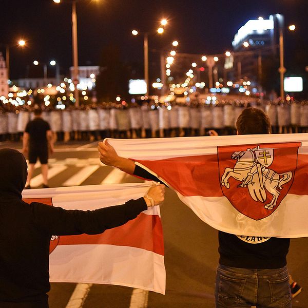 Demonstranter möts av en mur av säkerhetspoliser i Minsk