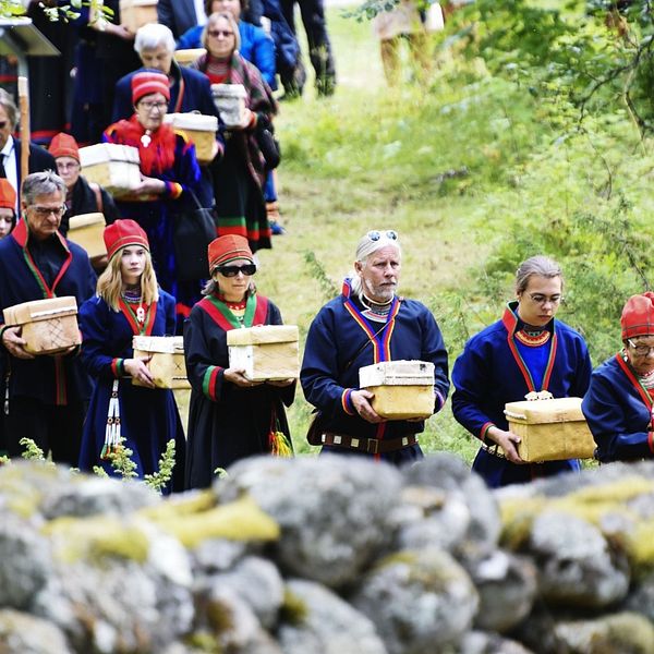 Procession mot gravplatsen där de 25 näveraskar som innehåller kvarlevor ska jordfästas under återbegravningen på försoningsceremonin vid Gammplatsen, Lycksele 9 augusti 2019