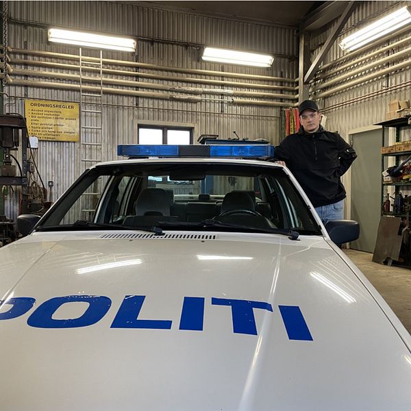 Gus Bäckström står bredvid som bild som liknar en äldre modell av en norskpolisbil.