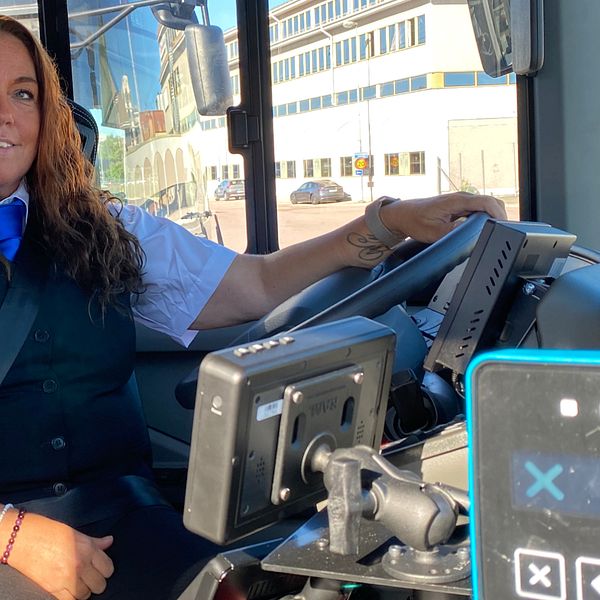 Busschauffören Susanne i Västerås sitter i förarstolen på sin buss.