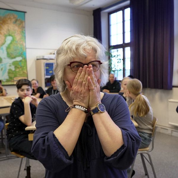 Lena Sjöblom håller händerna över munnen när hon överraskas av Lilla aktuellt i klassrummet