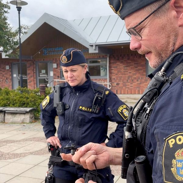 Två uniformerade poliser på torget i Surahammar.