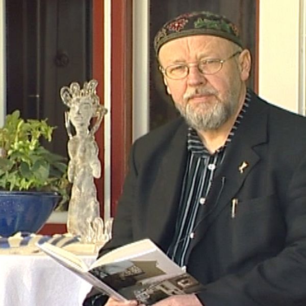 Bengt Berg på altanen med en bok