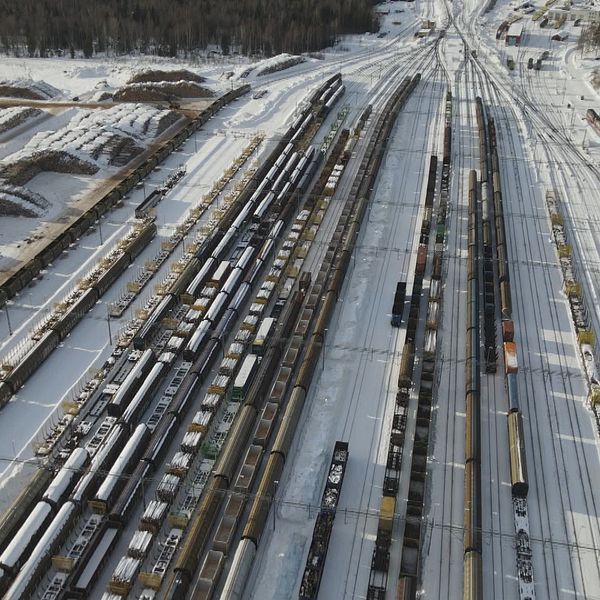 På bilden syns Ånge bangård filmas med drönare ovanifrån med järnvägsspår, tågvagnar och snö på marken.