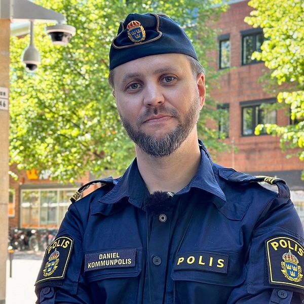 Kommunpolis Daniel Karlsson i Skellefteå centrum står framför en bevakningskamera