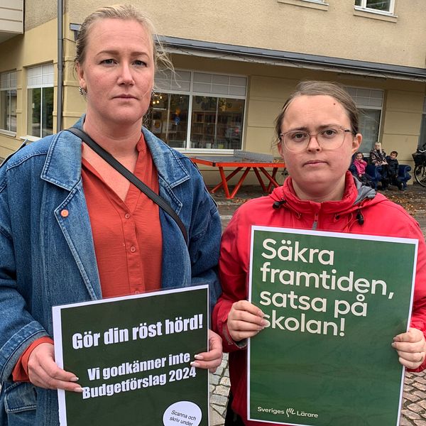 Lärare visar upp skylt och protesterar