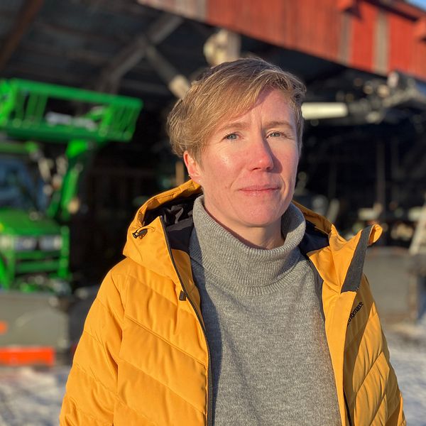 Samhällsbyggnadschefen i Vingåker, Susanne Jaktlund, står framför ett snöröjningsfordon och tittar in i kameran