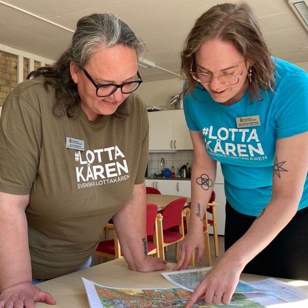 Carina och Sara är med i Svenska Lottakåren. Här står de och tittar på en karta.