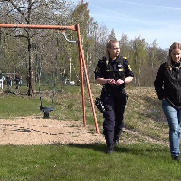Polisen Maja Karlsson tillsammans med SVTs reporter promenerar på en skolgård.