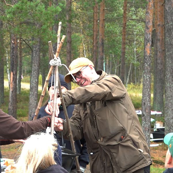 Naturskolalärare står vid en eld