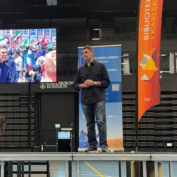Samir Abu Eid föreläser på scen i Karlskrona inför storbildsskärm